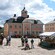 A village town square with cobblestone streets and a produce stand